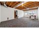 Unfinished basement space with exposed ceiling, painted walls, and walkout access to the backyard at 3835 Thornhill Sw Dr, Lilburn, GA 30047