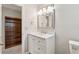 Updated bathroom featuring a marble vanity, framed mirror, and convenient access to a walk-in closet at 3835 Thornhill Sw Dr, Lilburn, GA 30047