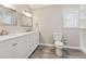 Bathroom featuring double sink vanity with marble countertop, toilet, and modern fixtures at 3835 Thornhill Sw Dr, Lilburn, GA 30047