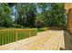 New wooden deck with railing overlooking the backyard at 3835 Thornhill Sw Dr, Lilburn, GA 30047