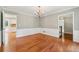 Spacious dining area with hardwood floors, wainscoting, chandelier, and open access to other rooms at 3835 Thornhill Sw Dr, Lilburn, GA 30047