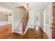 Elegant foyer featuring hardwood floors, staircase and chandelier, transitioning to carpeted living spaces at 3835 Thornhill Sw Dr, Lilburn, GA 30047