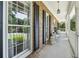 Inviting covered front porch with white railings and classic brick accents offering a serene outdoor living space at 3835 Thornhill Sw Dr, Lilburn, GA 30047