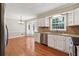 Bright kitchen featuring stainless steel appliances, granite countertops, breakfast bar, and hardwood floors at 3835 Thornhill Sw Dr, Lilburn, GA 30047