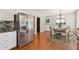 Open-concept kitchen featuring stainless steel appliances, granite countertops, and dining area at 3835 Thornhill Sw Dr, Lilburn, GA 30047