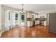 Spacious kitchen with stainless steel appliances, white cabinets, granite countertops, and adjacent breakfast area with deck access at 3835 Thornhill Sw Dr, Lilburn, GA 30047