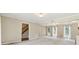 Spacious living room featuring natural light, a glimpse of the wooden staircase, and neutral-toned walls at 3835 Thornhill Sw Dr, Lilburn, GA 30047