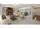 Cozy living room with a brick fireplace, built-in bookshelves, and view into dining area for easy entertaining at 3835 Thornhill Sw Dr, Lilburn, GA 30047
