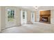 Bright living room featuring a brick fireplace, built-in shelves and cabinets, carpeted floor and lots of natural light at 3835 Thornhill Sw Dr, Lilburn, GA 30047