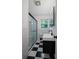 Modern bathroom showcasing sleek black and white tiles and a glass enclosed shower at 4051 Dixie Ln, Douglasville, GA 30135