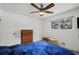 This bedroom features a ceiling fan, dresser, and window view at 4051 Dixie Ln, Douglasville, GA 30135