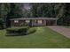 Charming brick home featuring a well-manicured lawn and covered carport at 4051 Dixie Ln, Douglasville, GA 30135