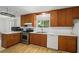 Functional kitchen featuring white countertops, stainless steel appliances, and wooden cabinets at 4051 Dixie Ln, Douglasville, GA 30135