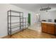 Bright kitchen featuring wire shelving, wood cabinets, and hardwood floors at 4051 Dixie Ln, Douglasville, GA 30135