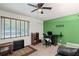 Comfortable living room featuring a green wall, ceiling fan and window with natural light at 4051 Dixie Ln, Douglasville, GA 30135