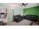 Inviting living room with comfortable seating, a green accent wall, and bright lighting at 4051 Dixie Ln, Douglasville, GA 30135