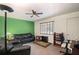 Cozy living room with comfortable black leather seating and a bright green accent wall at 4051 Dixie Ln, Douglasville, GA 30135