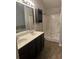 Bathroom features a double vanity sink, shower, and tile flooring at 5752 Little River Rd, Atlanta, GA 30349