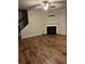 Inviting living room featuring hardwood floors, fireplace and a ceiling fan at 5752 Little River Rd, Atlanta, GA 30349