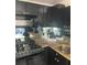 Contemporary kitchen with black cabinets, granite counters, and stainless appliances at 620 Peachtree #901 Ne St, Atlanta, GA 30308