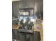 Modern kitchen with granite countertops, black cabinets, and stainless steel appliances at 620 Peachtree #901 Ne St, Atlanta, GA 30308