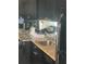 Functional kitchen featuring granite countertops, black appliances, and cabinetry at 620 Peachtree #901 Ne St, Atlanta, GA 30308