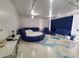 Unique living room with blue circular sofa and ocean-themed floor design at 620 Peachtree #901 Ne St, Atlanta, GA 30308