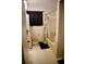 Bathroom with shower-tub combo, toilet, and neutral colored tile at 6264 Godfrey Sw Dr, Mableton, GA 30126