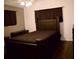 Cozy bedroom featuring dark wood furnishings and dark colored accents at 6264 Godfrey Sw Dr, Mableton, GA 30126