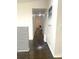 Long hallway featuring rich hardwood floors, neutral paint and access to other rooms at 6264 Godfrey Sw Dr, Mableton, GA 30126