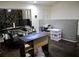 Functional home office space featuring dark wood floors, stone accent wall, and ample desk space at 6264 Godfrey Sw Dr, Mableton, GA 30126