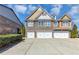 Charming townhouse featuring a multi-car garage and traditional architectural details at 805 Pleasant Hill Nw Rd # 343, Lilburn, GA 30047