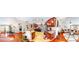 Open-concept living space features hardwood flooring, a fireplace, and an open kitchen-living room design at 805 Pleasant Hill Nw Rd # 343, Lilburn, GA 30047