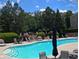 Beautiful community pool with lounge chairs and mature landscaping at 805 Pleasant Hill Nw Rd # 343, Lilburn, GA 30047