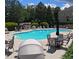 Community pool with lounge chairs and lush landscaping in a well-maintained setting at 805 Pleasant Hill Nw Rd # 343, Lilburn, GA 30047