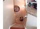 Carpeted stairs leading down to a lower level featuring tile floors, with a clock on the wall at 805 Pleasant Hill Nw Rd # 343, Lilburn, GA 30047