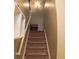 Carpeted staircase with white banisters, leading to the upper level of the home at 805 Pleasant Hill Nw Rd # 343, Lilburn, GA 30047