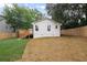 Exterior view of the home, featuring a deck and a grassy backyard at 942 Mclinden Se Ave, Smyrna, GA 30080