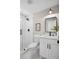 Modern bathroom boasts a glass shower, white vanity, black fixtures, and stylish décor at 942 Mclinden Se Ave, Smyrna, GA 30080