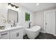 Stylish bathroom featuring a modern soaking tub, sleek vanity, and elegant fixtures at 942 Mclinden Se Ave, Smyrna, GA 30080
