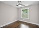 This bedroom provides pristine white trim with gleaming hardwood flooring and a ceiling fan at 942 Mclinden Se Ave, Smyrna, GA 30080