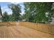 Spacious wood deck with railing, perfect for outdoor relaxation and enjoying the surrounding greenery at 942 Mclinden Se Ave, Smyrna, GA 30080