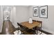 Open dining area with a wooden table, four chairs, two framed arts and hardwood floors at 942 Mclinden Se Ave, Smyrna, GA 30080