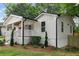 Charming exterior view with white siding, a covered porch, and manicured landscaping at 942 Mclinden Se Ave, Smyrna, GA 30080
