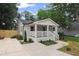Captivating exterior view featuring white siding, a cozy front porch, and lush landscaping at 942 Mclinden Se Ave, Smyrna, GA 30080