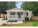 Charming craftsman-style home with a welcoming front porch and blue front door at 942 Mclinden Se Ave, Smyrna, GA 30080