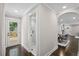 View of bathroom and hall with hardwood floors, leading to a dining area and door to deck at 942 Mclinden Se Ave, Smyrna, GA 30080