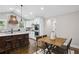 Spacious kitchen with a large island, a breakfast nook and stainless steel appliances, with modern lighting at 942 Mclinden Se Ave, Smyrna, GA 30080