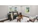 Cozy living room with large windows providing natural light and a comfortable sofa at 942 Mclinden Se Ave, Smyrna, GA 30080