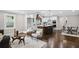Open-concept living space with hardwood floors, kitchen with island, and dining area at 942 Mclinden Se Ave, Smyrna, GA 30080